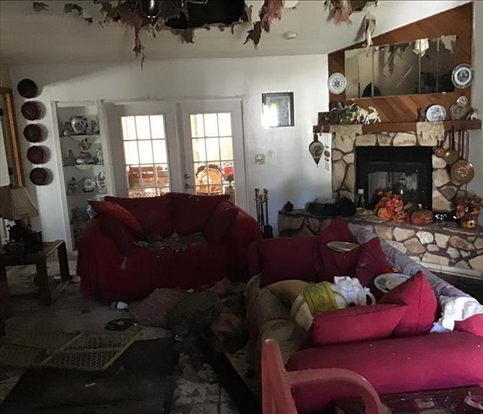 living room covered with debri from fire damage